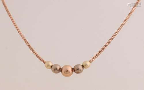 Golden necklace with spheres