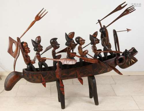 African woodcarved boat with warriors