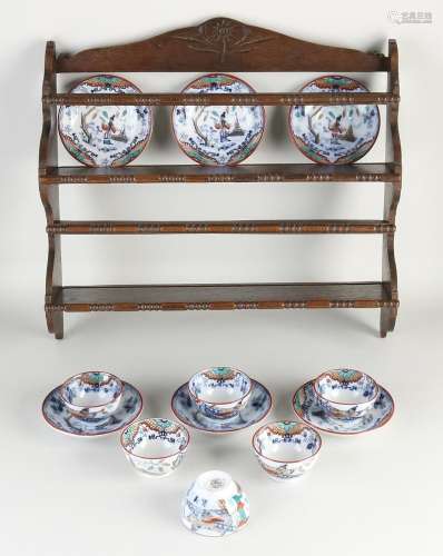 Antique wall rack with cups and saucers, 1900