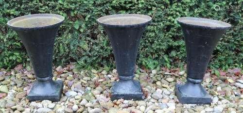 Three cast iron garden vases, H 55 cm.
