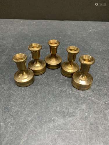 Lot of five vintage brass candle stick holders or paper weig...