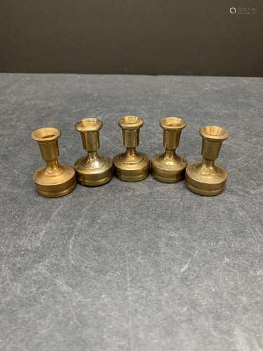 Lot of five vintage brass candle stick holders or paper weig...