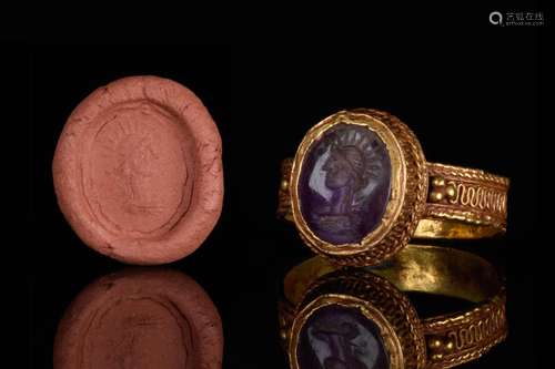 A GOLD RING WITH ROMAN AMETHYST INTAGLIO DEPICTING SOL INVIC...