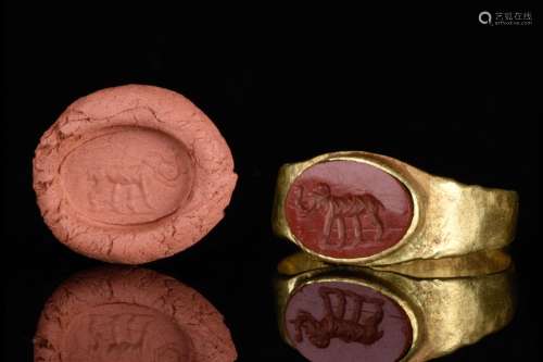 A ROMAN GOLD AND CARNELIAN INTAGLIO RING DEPICTING AN ELEPHA...