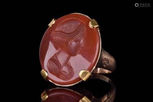 A POST CLASSICAL GOLD RING WITH INTAGLIO DEPICTING BUST OF E...