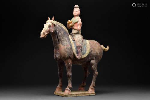 A CHINESE TANG DYNASTY TERRACOTTA HORSE AND RIDER WITH TL TE...