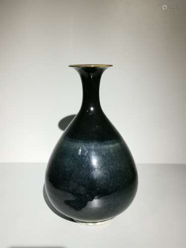 An aubergine glazed vase