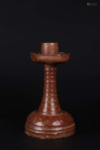 A red glaze candle stick