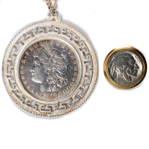 A ( a 1882 Morgan dollar mounted in a Greek key bezel surrou...