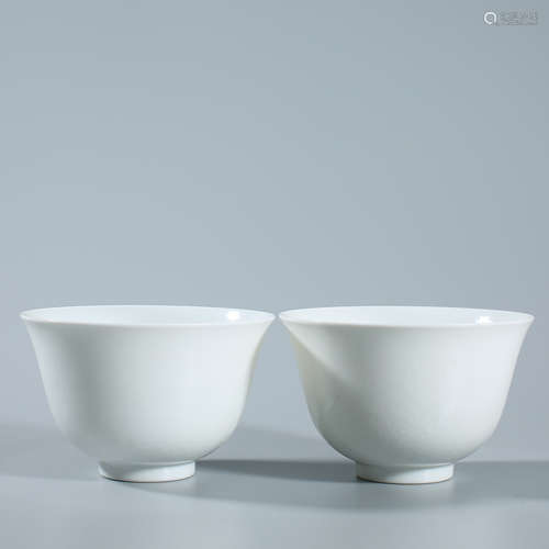 A pair of white glazed cups