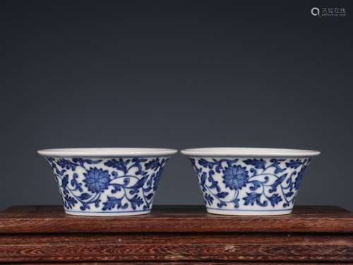 A pair of blue and white horseshoe cups