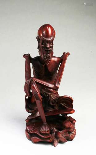 A Carved Wooden Monk Figurine