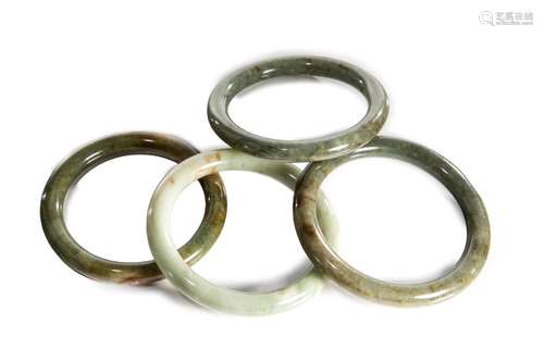 FOUR CHINESE JADE BANGLE BRACELETS