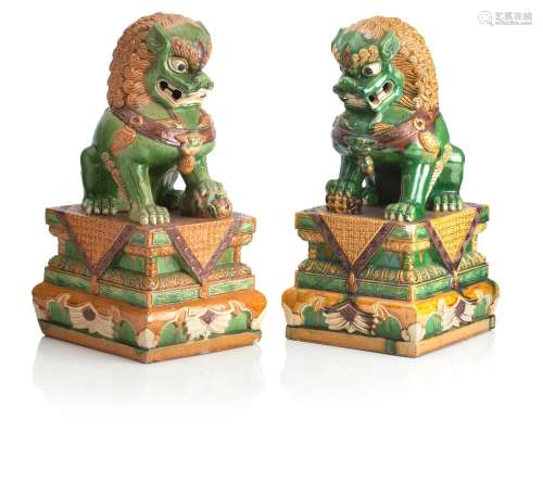 A PAIR OF LARGE POTTERY BUDDHISTIC LIONS