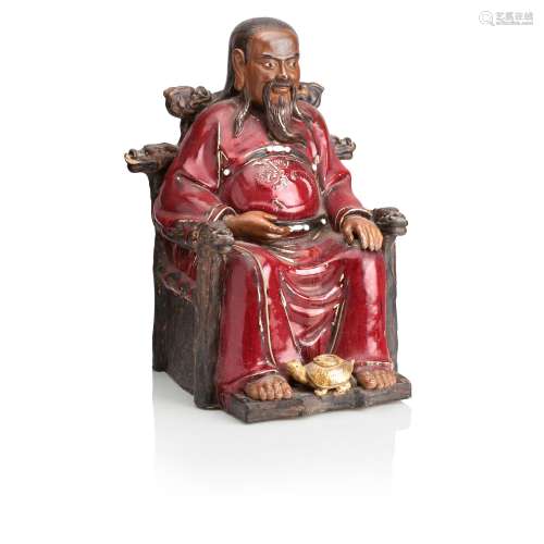A EARLY 20TH CENTURY CHINESE RED GLAZED TERACOTTA FIGURE OF ...