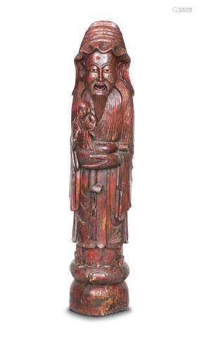 A CHINESE RED LACQUER CARVED ELM FIGURE OF SHOU LAO