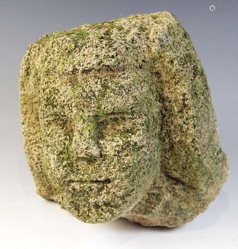 A stone head in the medieval manner, 24.5cm high (very worn)