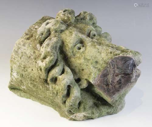 A carved stone corbel, depicting a bearded male head with di...