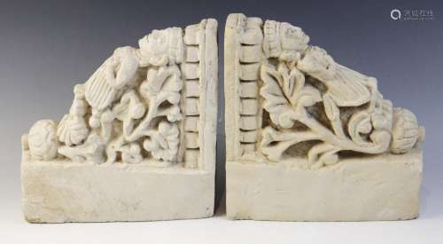 A pair of carved stone brackets, each depicting a female fig...