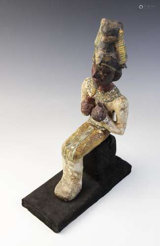 An Egyptian style gesso painted seated wood figure of a phar...