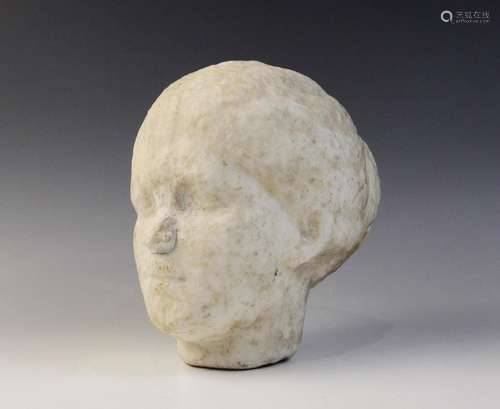 A Roman style head of a young woman, with worn features, her...