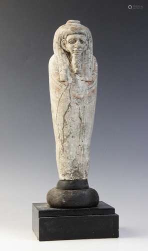 An Egyptian style limestone mummiform figure with lappet wig...