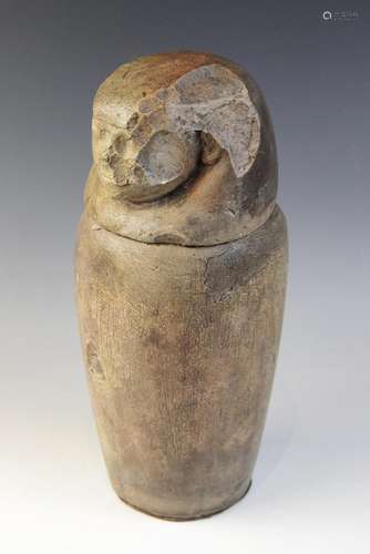 An Egyptian style limestone canopic jar, the stopper in the ...