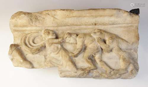 A marble fragmentary relief depicting a spotted hound or pan...