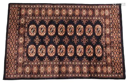 * A small hand woven bokhara wool carpet, of typical design,...