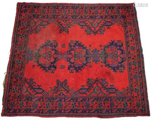 A Turkish wool rug, in red, blue and green colourways, the t...