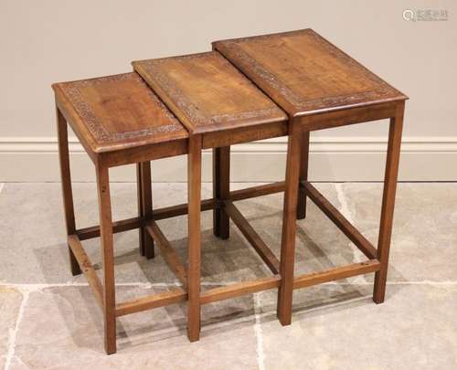 * A nest of three Chinese carved teak tables, early 20th cen...