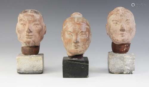 Three Chinese terracotta heads, possibly Han dynasty, each b...