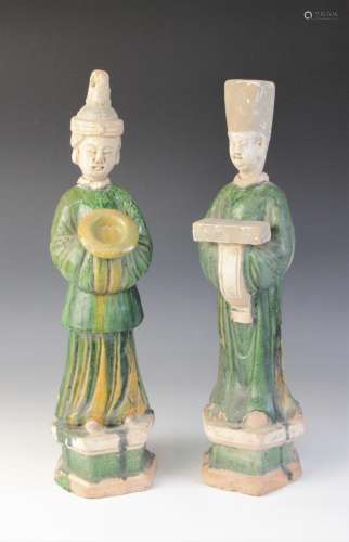 A pair of large Chinese Sancai glazed attendants, possibly M...