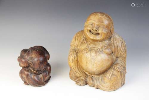 An Eastern carved figure of a Buddha, modelled seated laughi...