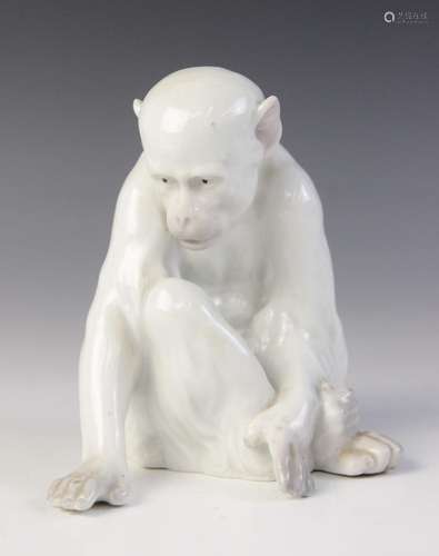 A porcelain figure of a monkey observing its hand, probably ...