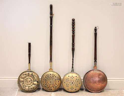 A 17th/18th century Dutch brass warming pan, the domed cover...