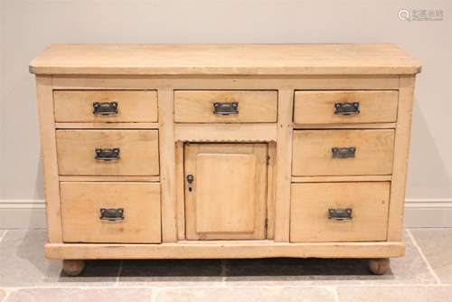 * A Victorian pine dresser base, the slab top above an arran...