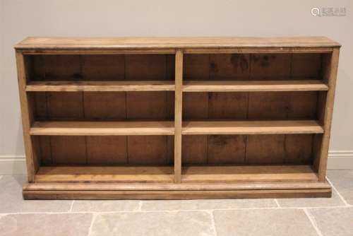 * A Victorian style stripped oak and pine open bookcase, the...