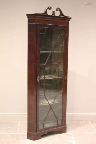 * An Edwardian mahogany freestanding corner display cabinet,...