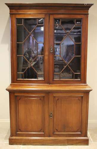 * An Edwardian walnut library bookcase, with a moulded and d...