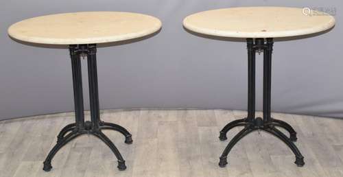 Pair of circular cream marble tables raised on iron column s...