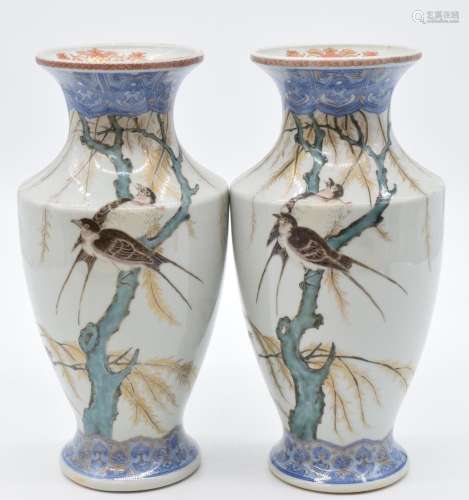 A pair of Japanese porcelain pedestal vases with enamelled d...