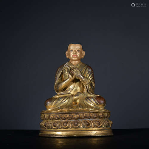 A gilt-bronze statue of Guru