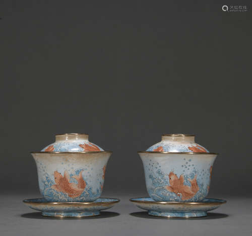 A pair of enamel 'fish' teacup