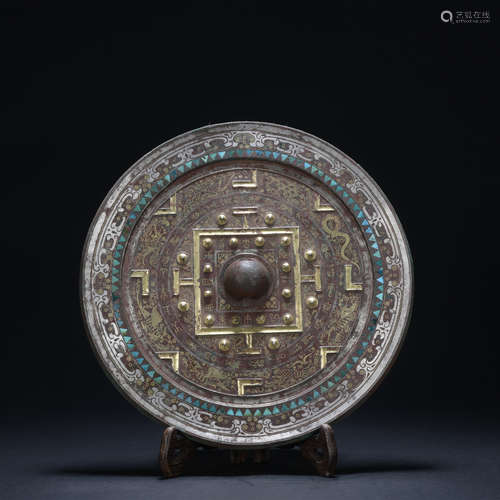 A bronze mirror ware with gold and silver