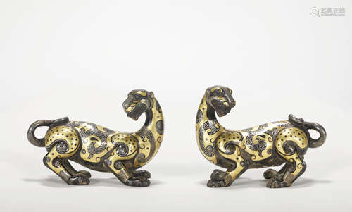 A pair of bronze beast ware with gold and silver