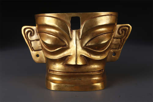 A Gilt Copper Mask.