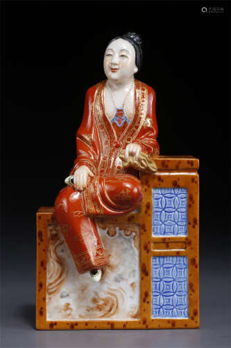 An Iron-Red Porcelain Sitting Figure Statue.
