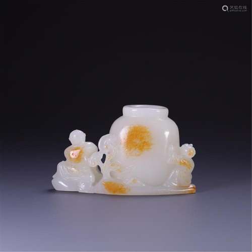 A CHINESE JADE BOY FLOWER HOLDER