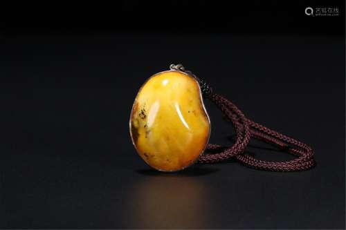 A CHINESE AMBER PENDANT COVERED SILVER